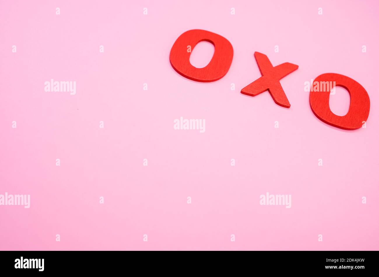 A top view of 0x0 written with wooden numbers on a pink surface Stock Photo