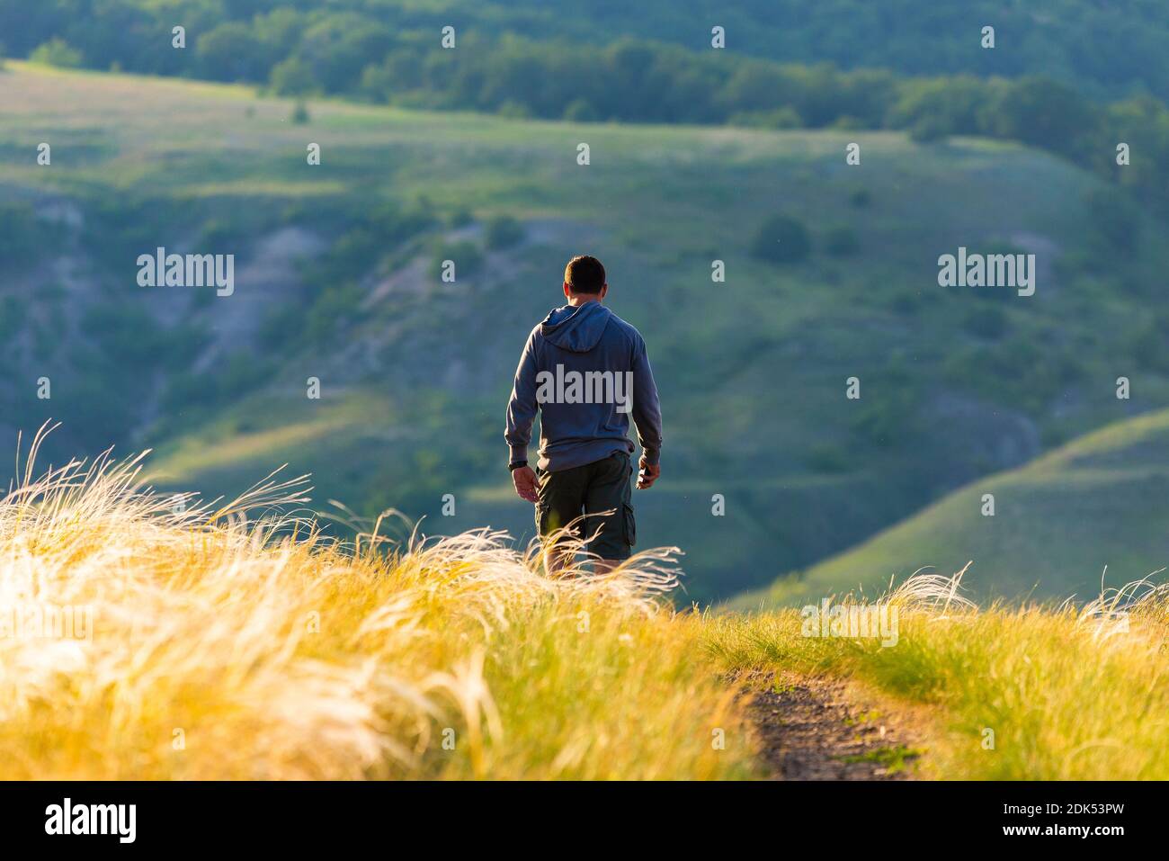 Lonely man walking sunset hi-res stock photography and images - Alamy