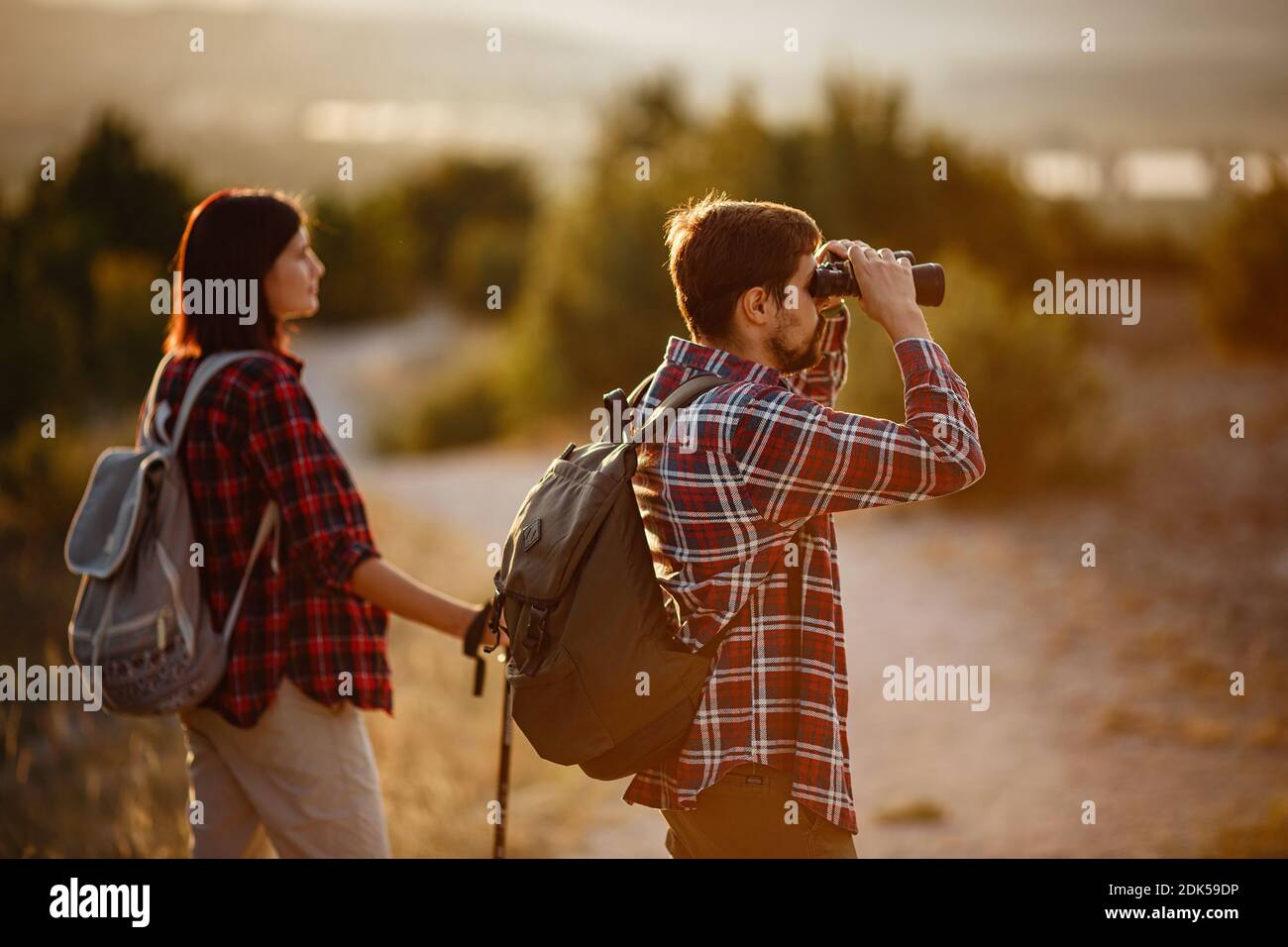 Portrait of happy young couple having fun on their hiking trip ...