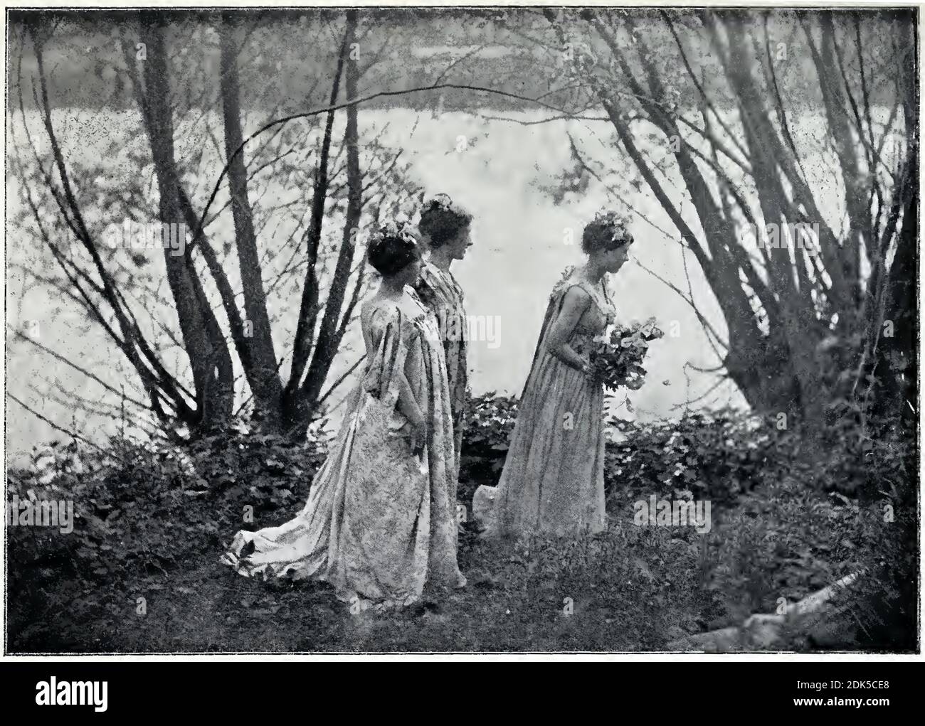 Vintage photograph by the French pictorialist photographer Émile Joachim Constant Puyo. 3 women with flowers in their hair in a piece called Theorie. Stock Photo