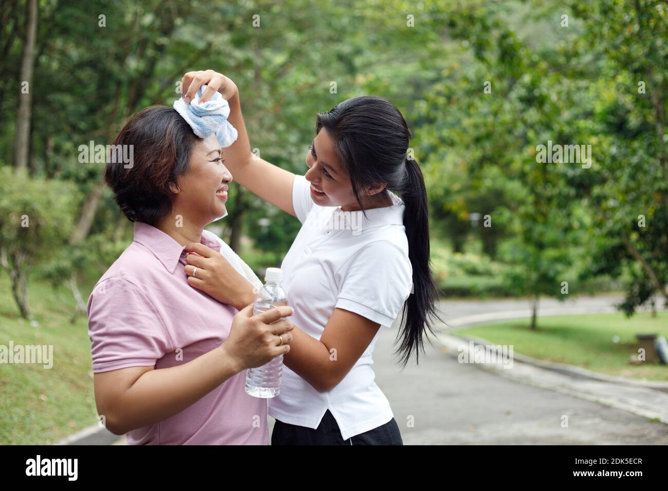 Daughter Wiping Mother Sweat After Exercising Stock Photo - Alamy