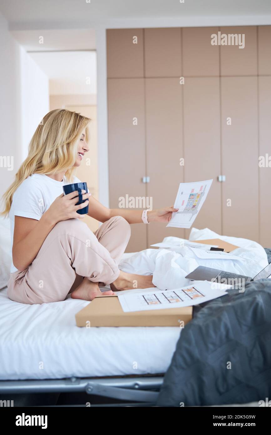 Positive delighted blonde working with great inspiration Stock Photo