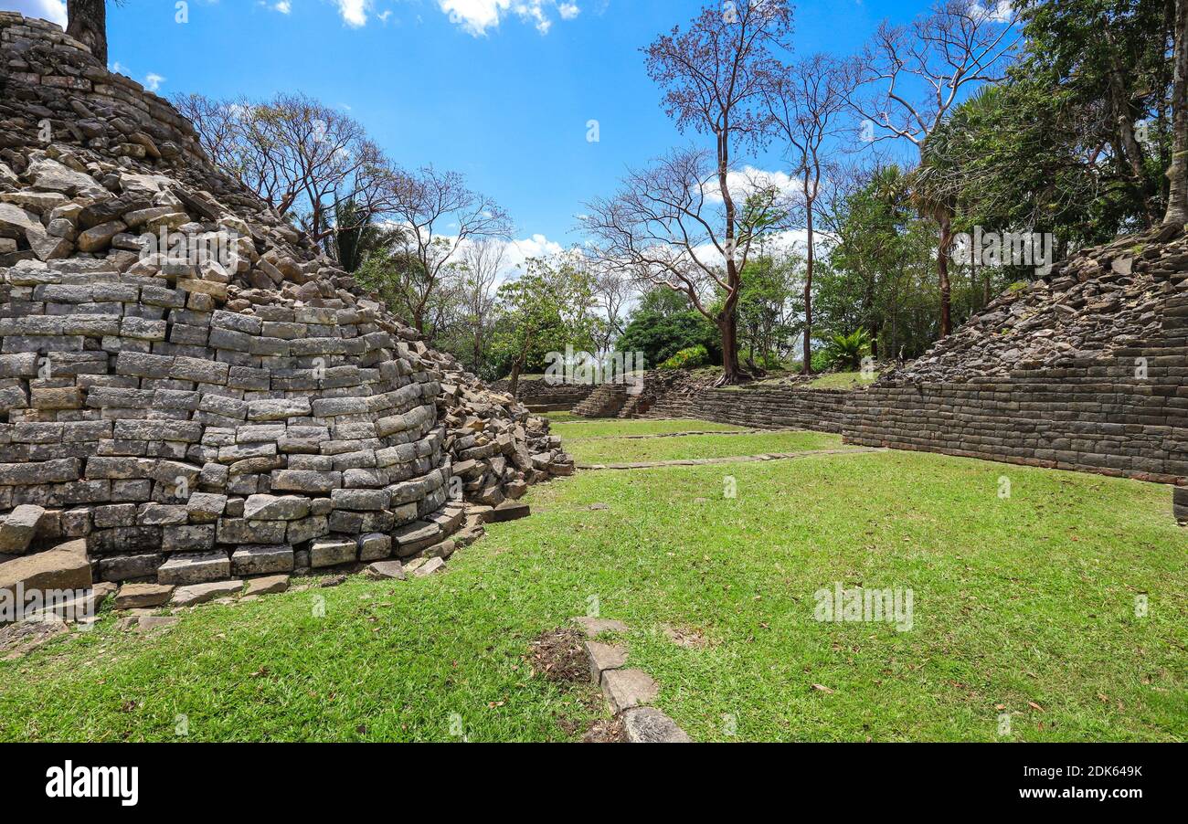 TOLEDO DISTRICT, BELIZE - Jun 10, 2019: A path allows visitors to walk amongst the preserved ruins at Lubaantun Mayan Archaeological Site in Southern Stock Photo