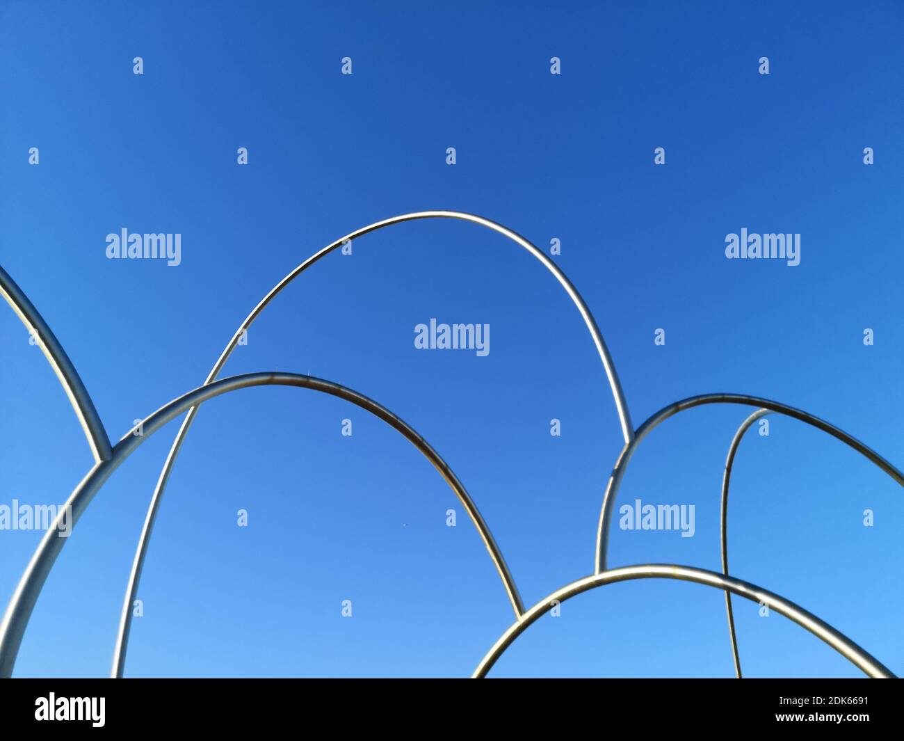 Low Angle View Of Metal Fence Against Clear Blue Sky Stock Photo