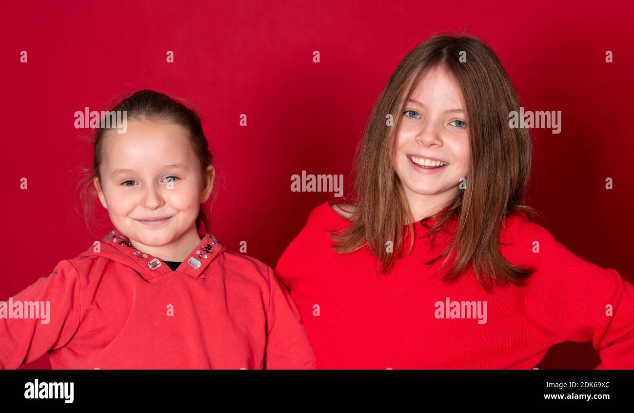Best Girlfriends Wearing Red Clothes In Front Of Red Background Stock Best Girlfriends Wearing Red Clothes In Front Of Red Background Stock