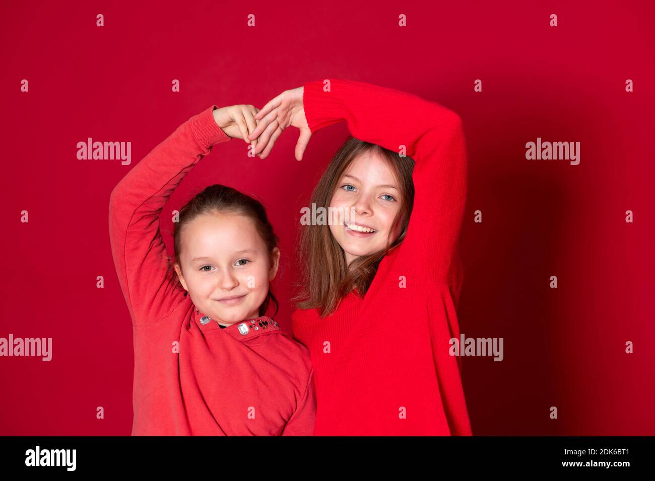Best Girlfriends Wearing Red Clothes In Front Of Red Background Stock Best Girlfriends Wearing Red Clothes In Front Of Red Background Stock
