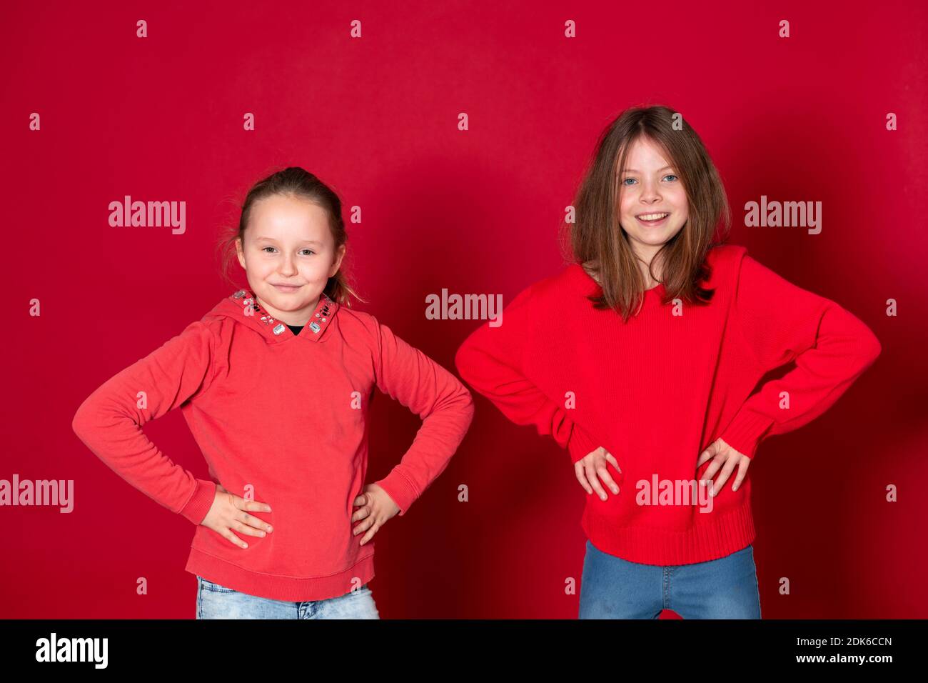 Best Girlfriends Wearing Red Clothes In Front Of Red Background Stock Best Girlfriends Wearing Red Clothes In Front Of Red Background Stock