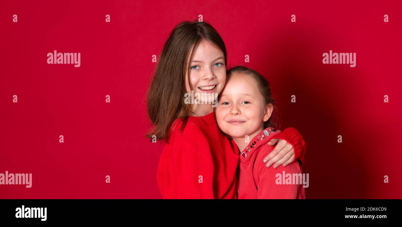 Best Girlfriends Wearing Red Clothes In Front Of Red Background Stock Best Girlfriends Wearing Red Clothes In Front Of Red Background Stock