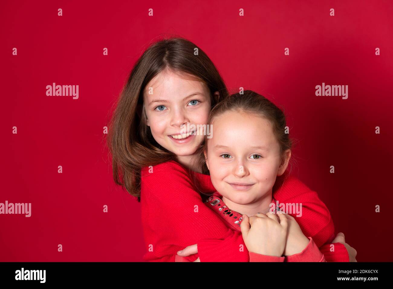 Best Girlfriends Wearing Red Clothes In Front Of Red Background Stock Best Girlfriends Wearing Red Clothes In Front Of Red Background Stock