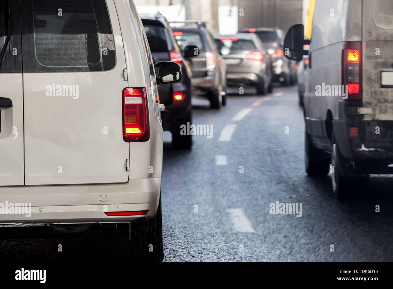 Cars move in a jam along city streets. Rush hour. Back view Stock Photo ...