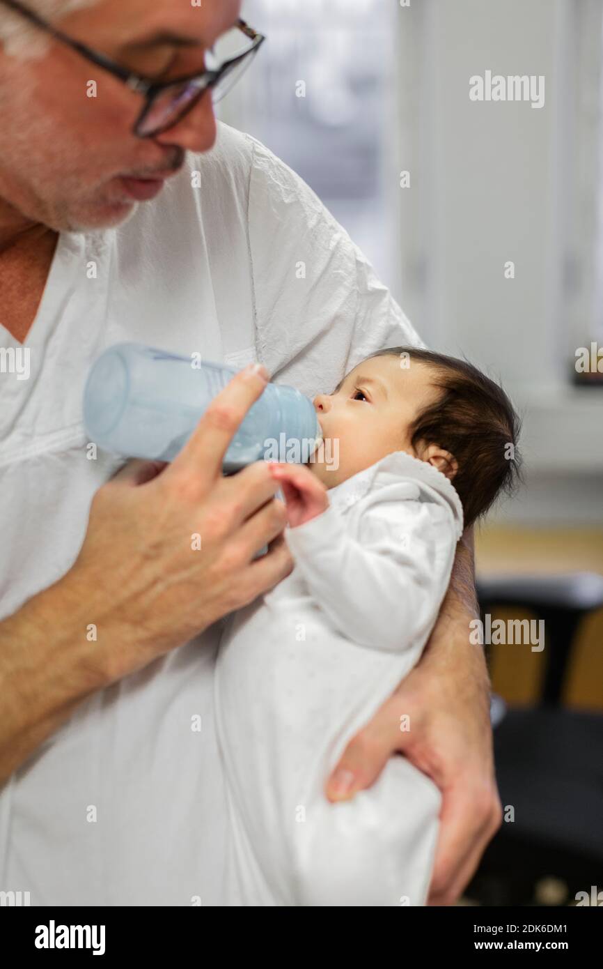 Doctor feeding newborn baby Stock Photo