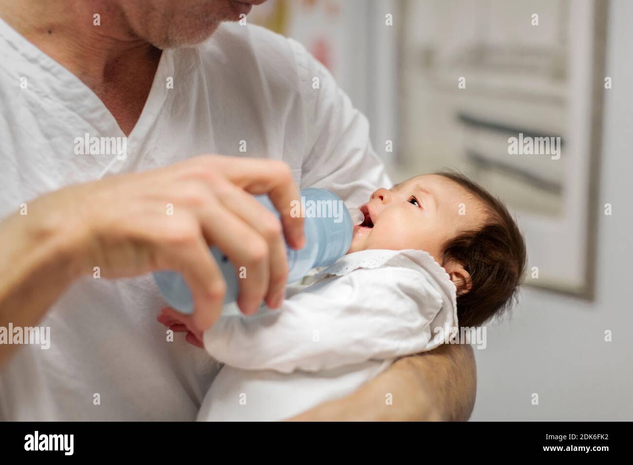 Doctor feeding newborn baby Stock Photo