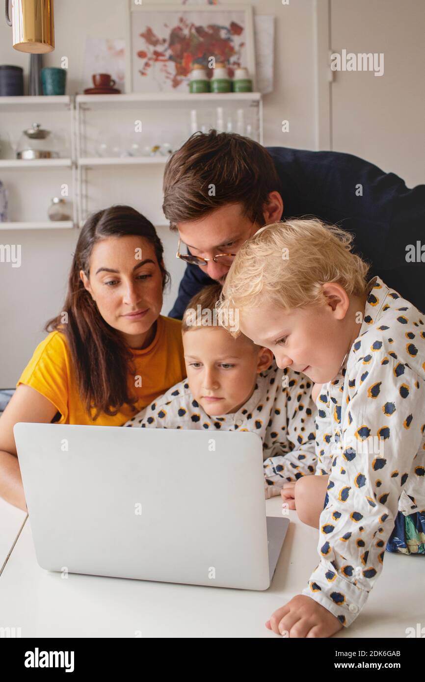 Family at home using laptop Stock Photo