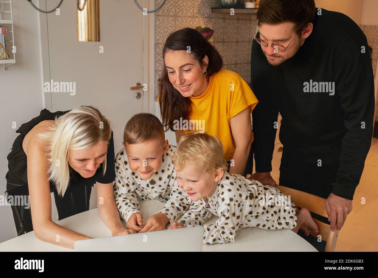 Family with kids using laptop Stock Photo
