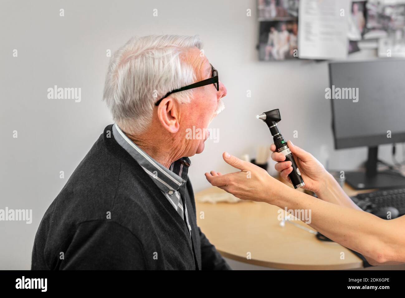 Doctor checking patient's throat Stock Photo Alamy