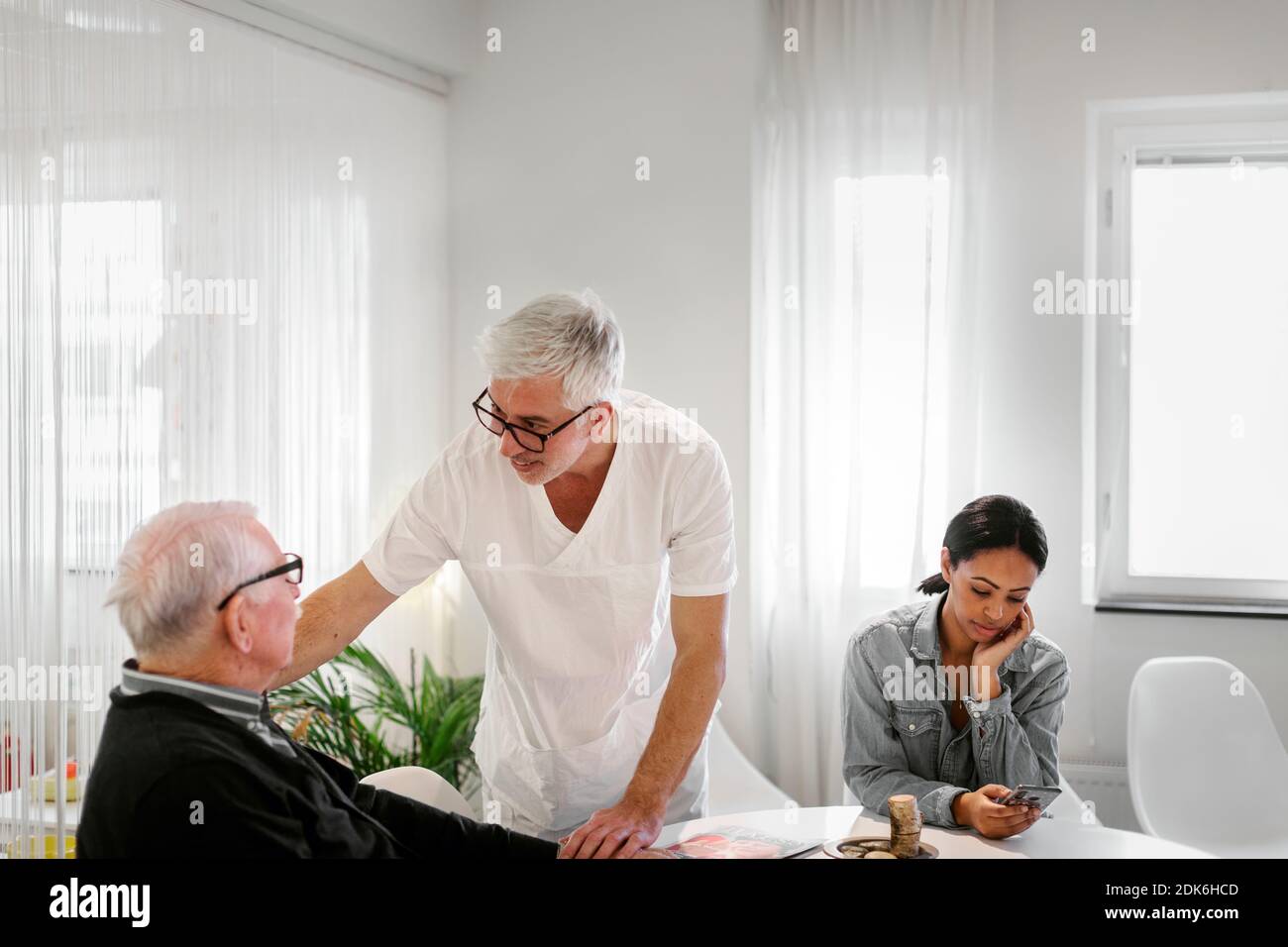 Doctor talking to patient in waiting room Stock Photo