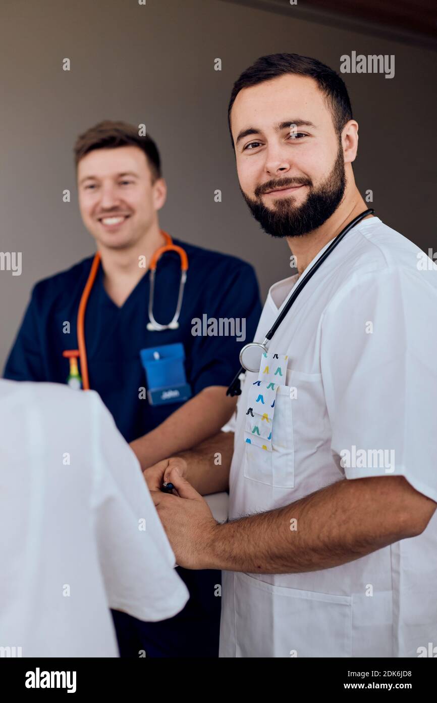 Smiling mature doctor working hi-res stock photography and images - Alamy