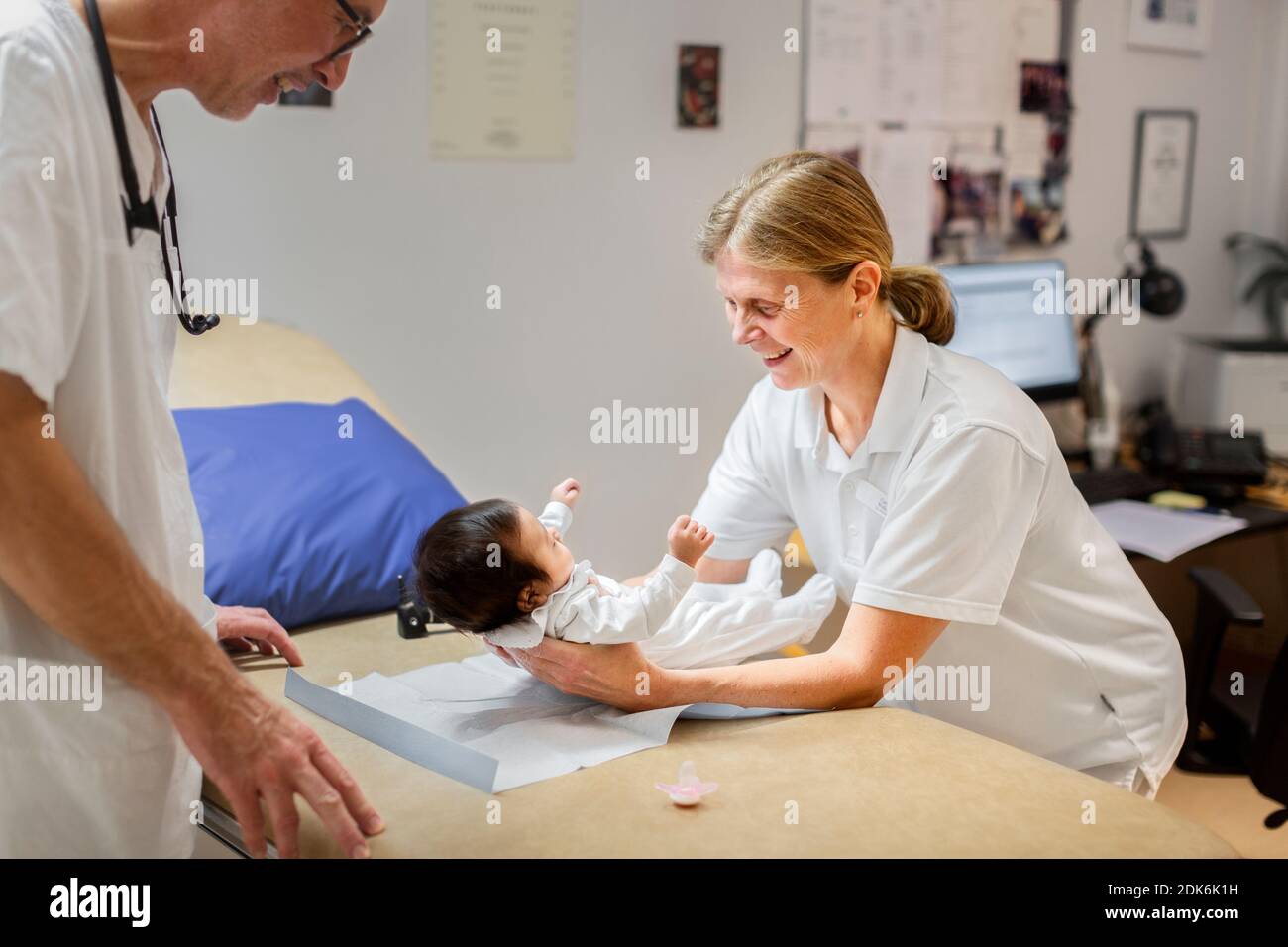 Female doctor examining baby Stock Photo