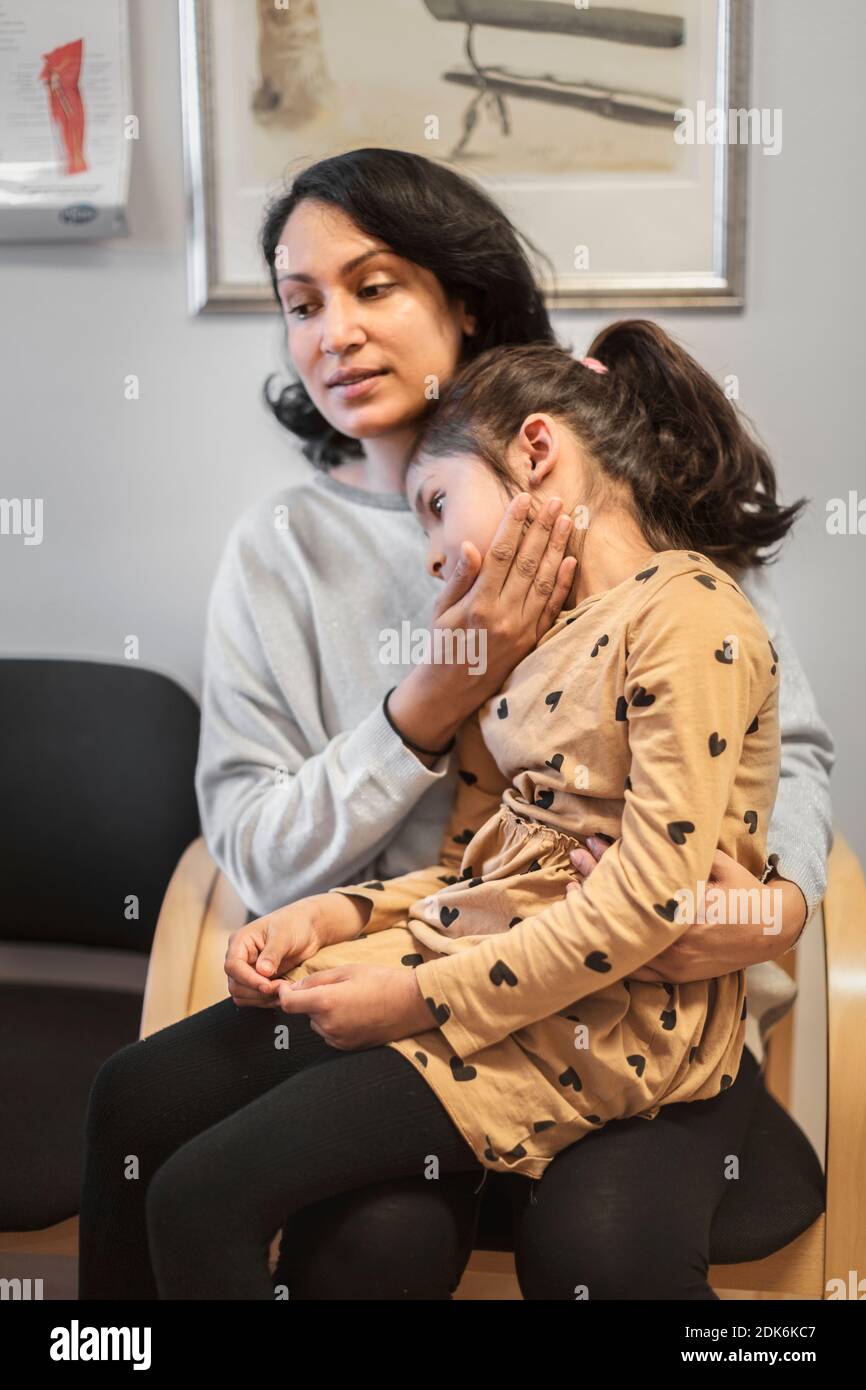 Mother and daughter waiting in doctor's surgery Stock Photo