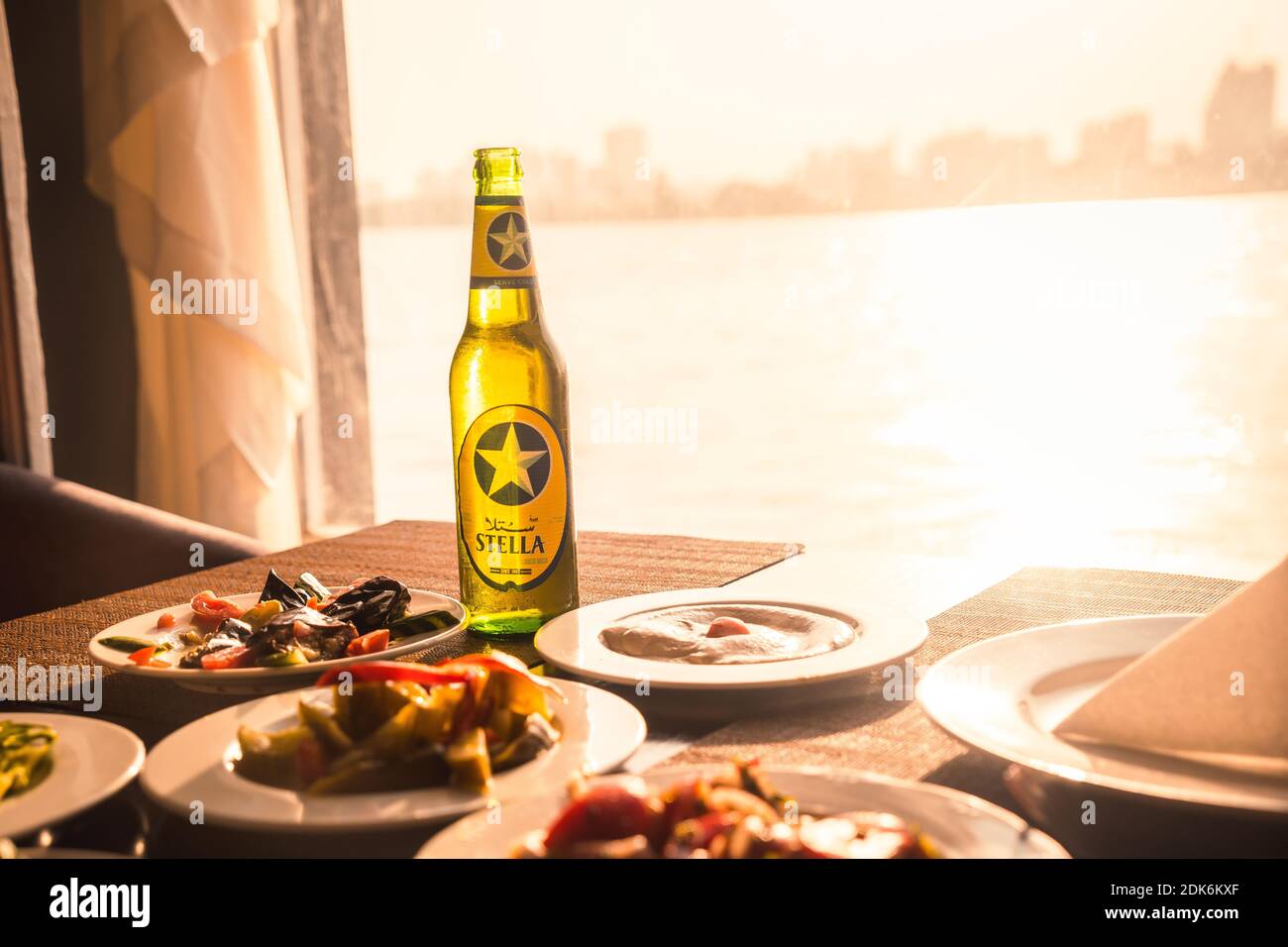 CAIRO, EGYPT - Oct 09, 2020: Cairo, Egypt; October 2020: A traditional dinner of the country accompanied by a Stella, local beer at the sunset of the Stock Photo