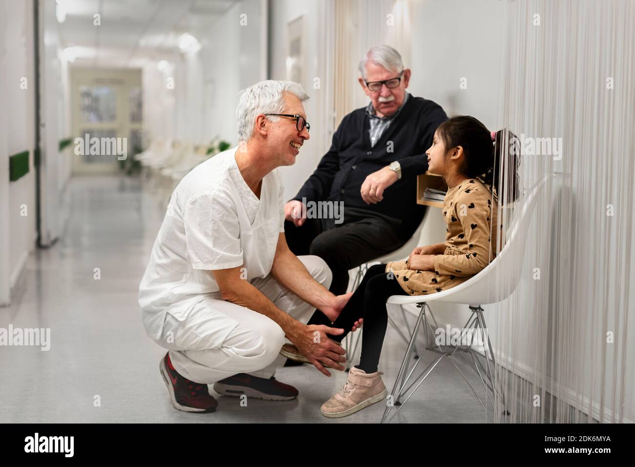 Doctor talking to girl waiting for appointment Stock Photo