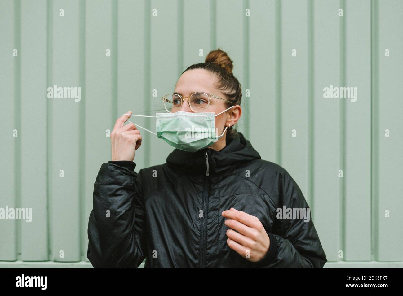 Woman putting on face mask hi-res stock photography and images - Alamy