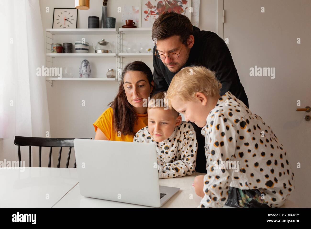 Family at home using laptop Stock Photo