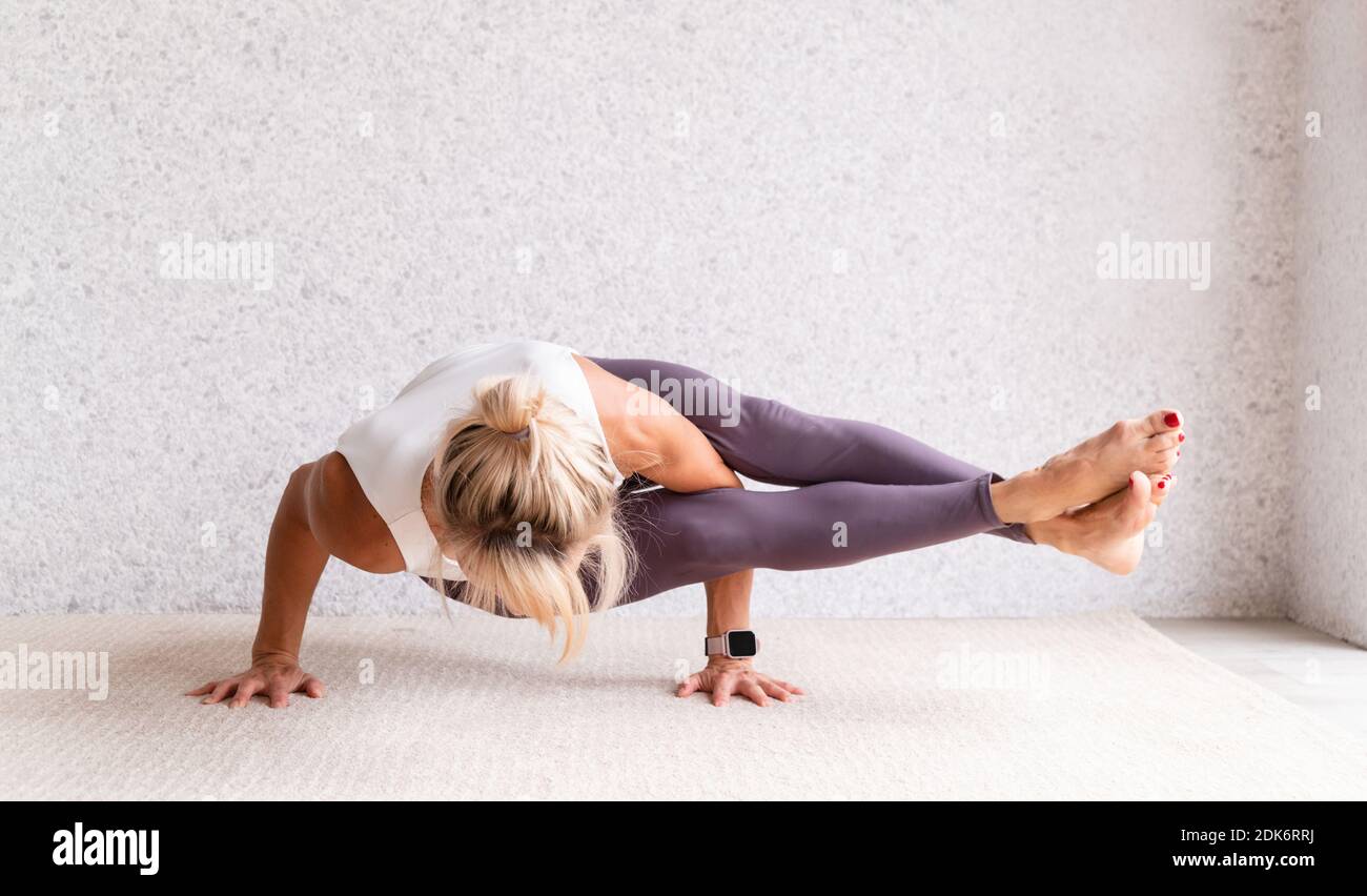 Woman With Arms Raised Against Wall Stock Photo Alamy