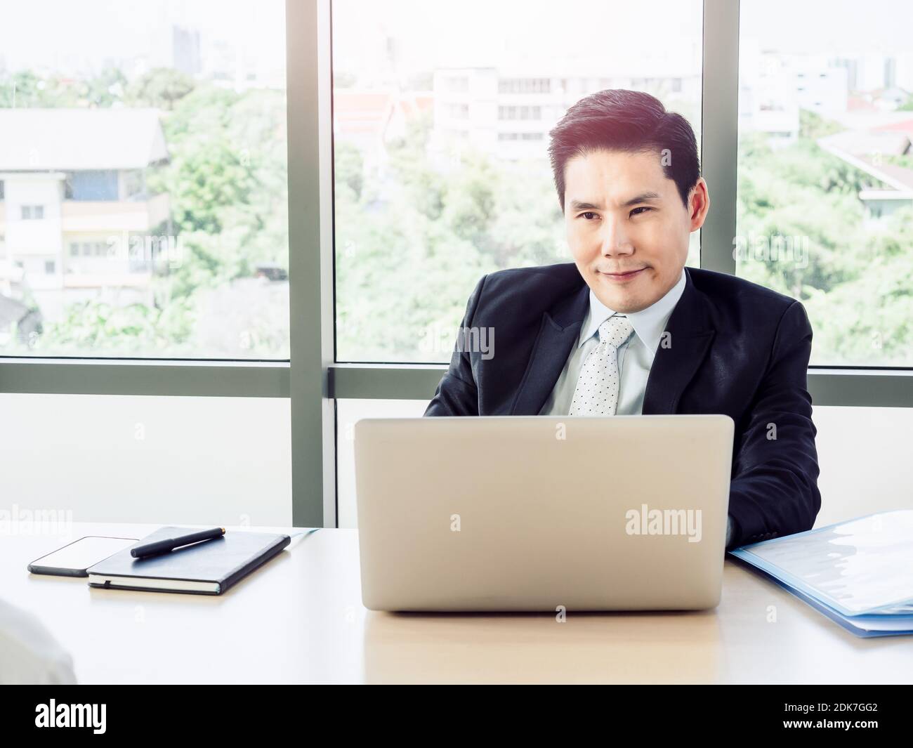 Asian businessman, employer in suit looking and listening with someone candidate, job interview with laptop computer on desk in office. Job interview, Stock Photo