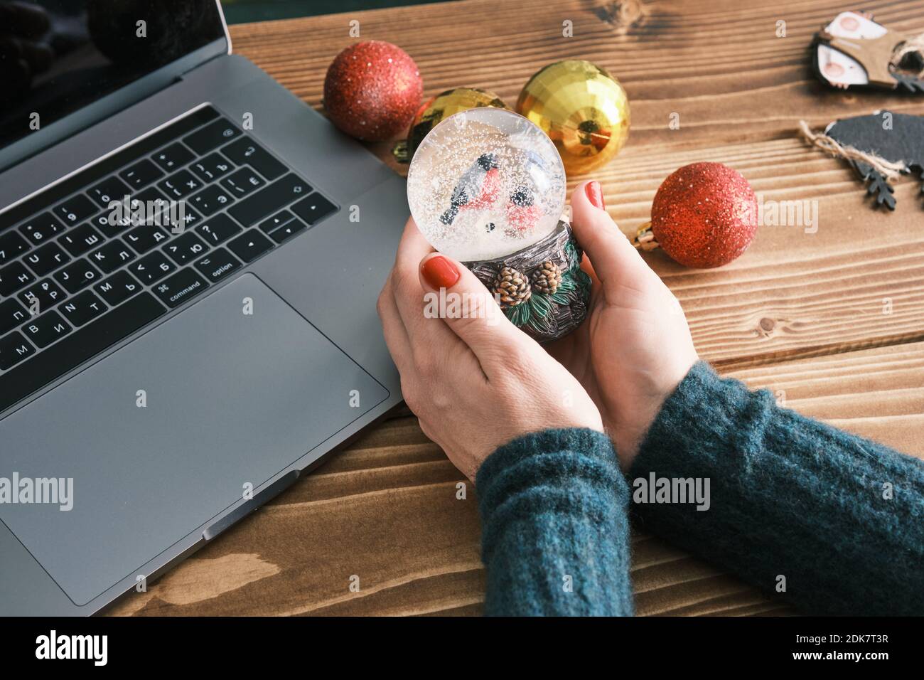 Closeup of Snow Globe Snow Flakes and birds in hands, Beautiful Holiday Concept with Christmas toys. Working at home Stock Photo