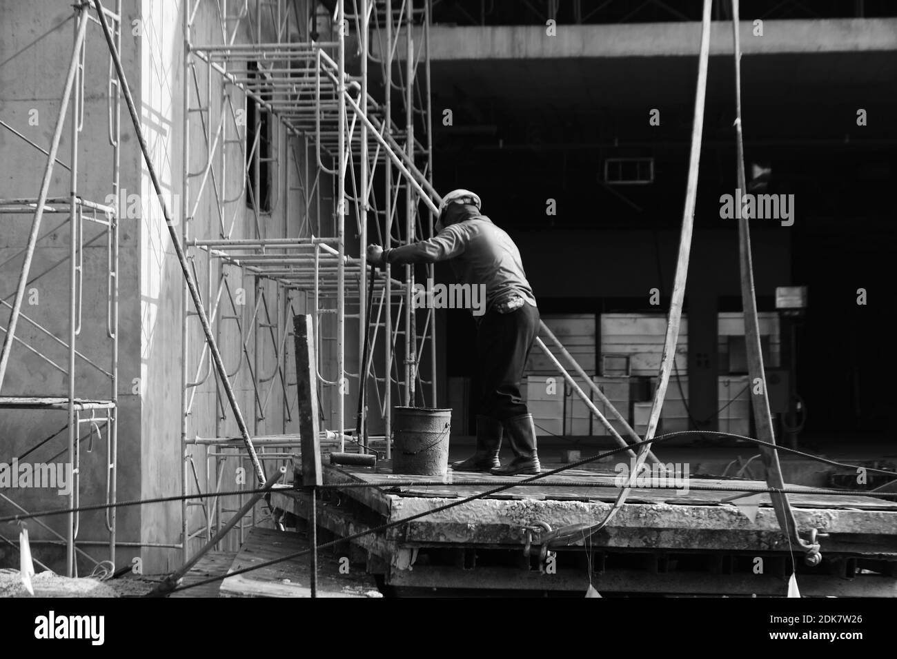 Full Length Of Manual Worker Working At Construction Site Stock Photo