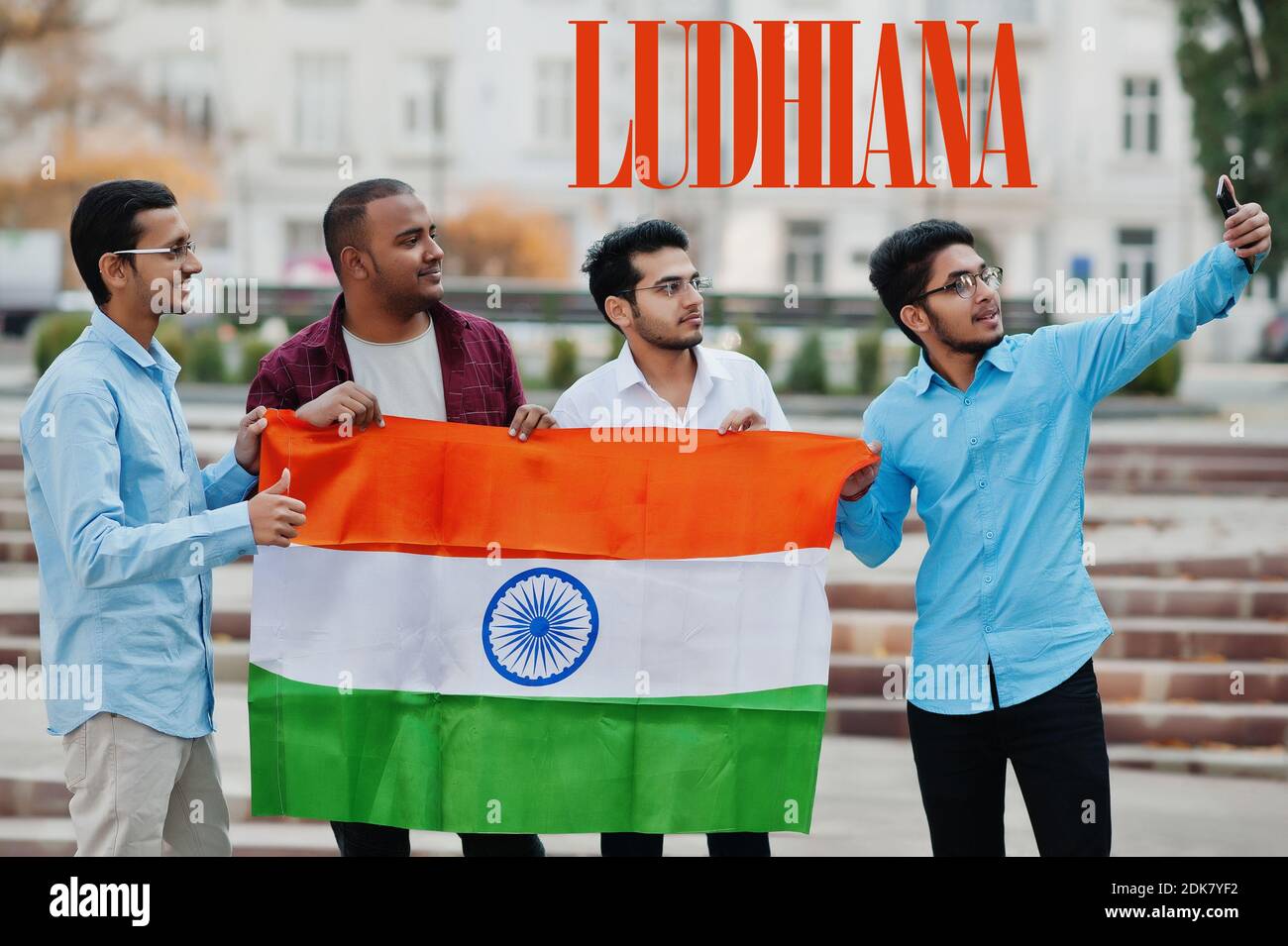 Ludhiana city inscription. Group of four indian male friends with India flag making selfie on mobile phone. Largest India cities concept. Stock Photo
