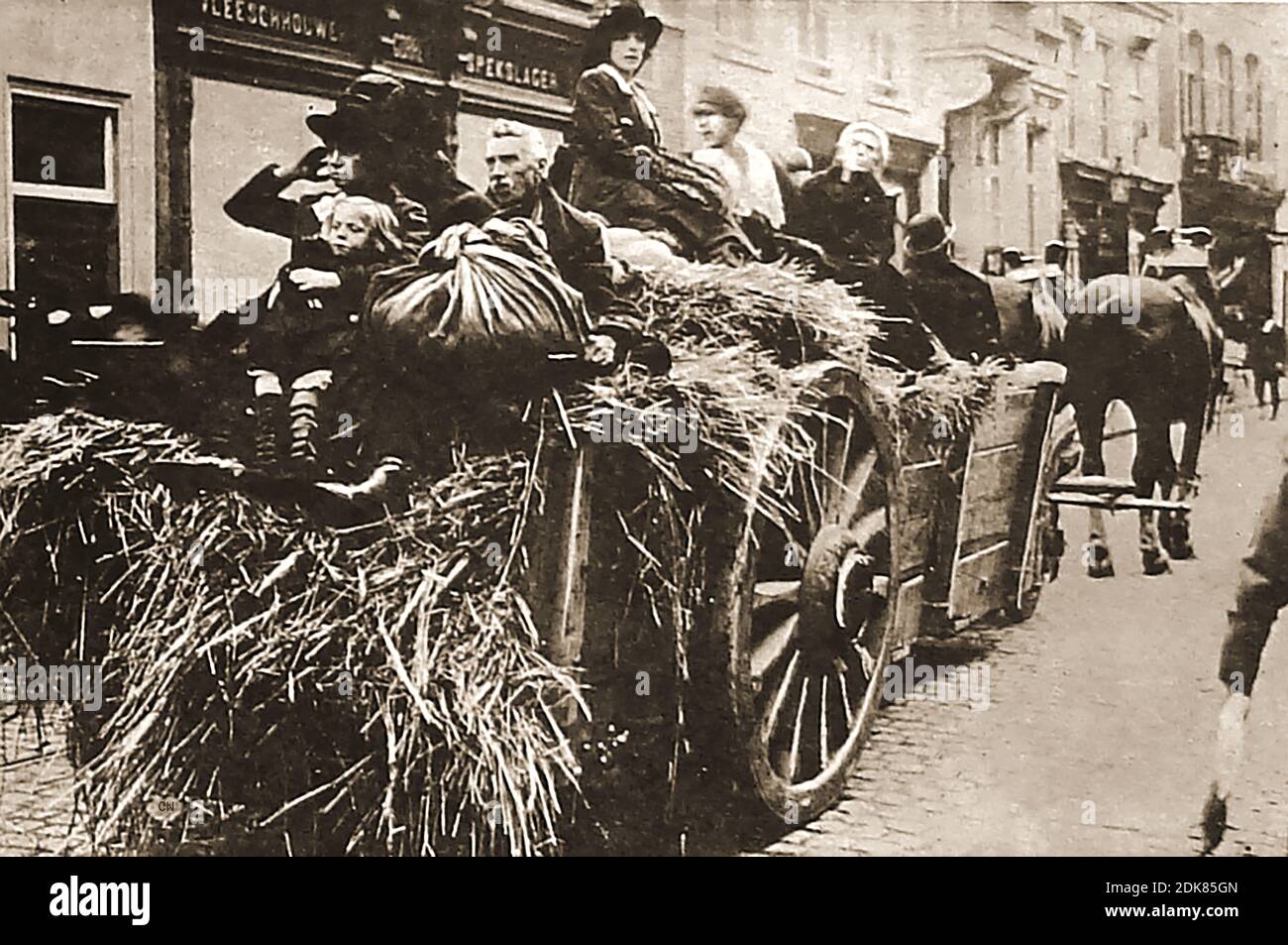 WWI  1914 -  Belgian refugees fleeing from the advancing Nazi's using  an old hay cart and carrying  their  most prcious possessions wrapped in tied up cloth bags. Germany invaded Belgium on the 4th August 1914, following the Belgian authorities denying them  free passage through Belgium on their way to Paris.  Thousands of Belgian subjects fled to Britain and many of their citizens joined the British army. 25,000 wounded Belgian soldiers convalesced in Britain after fighting on the front. Stock Photo