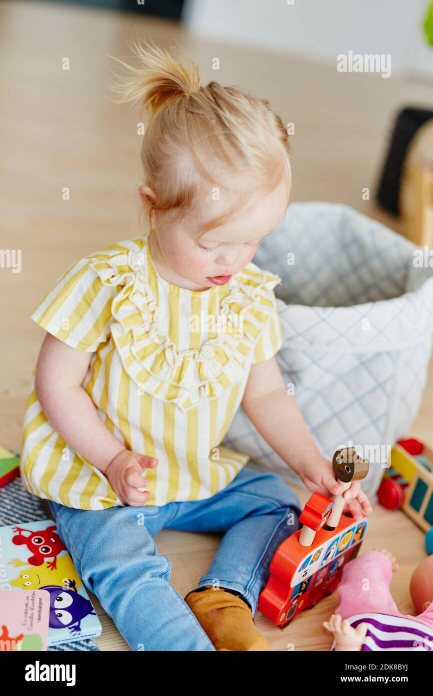 Girl playing with toys Stock Photo - Alamy