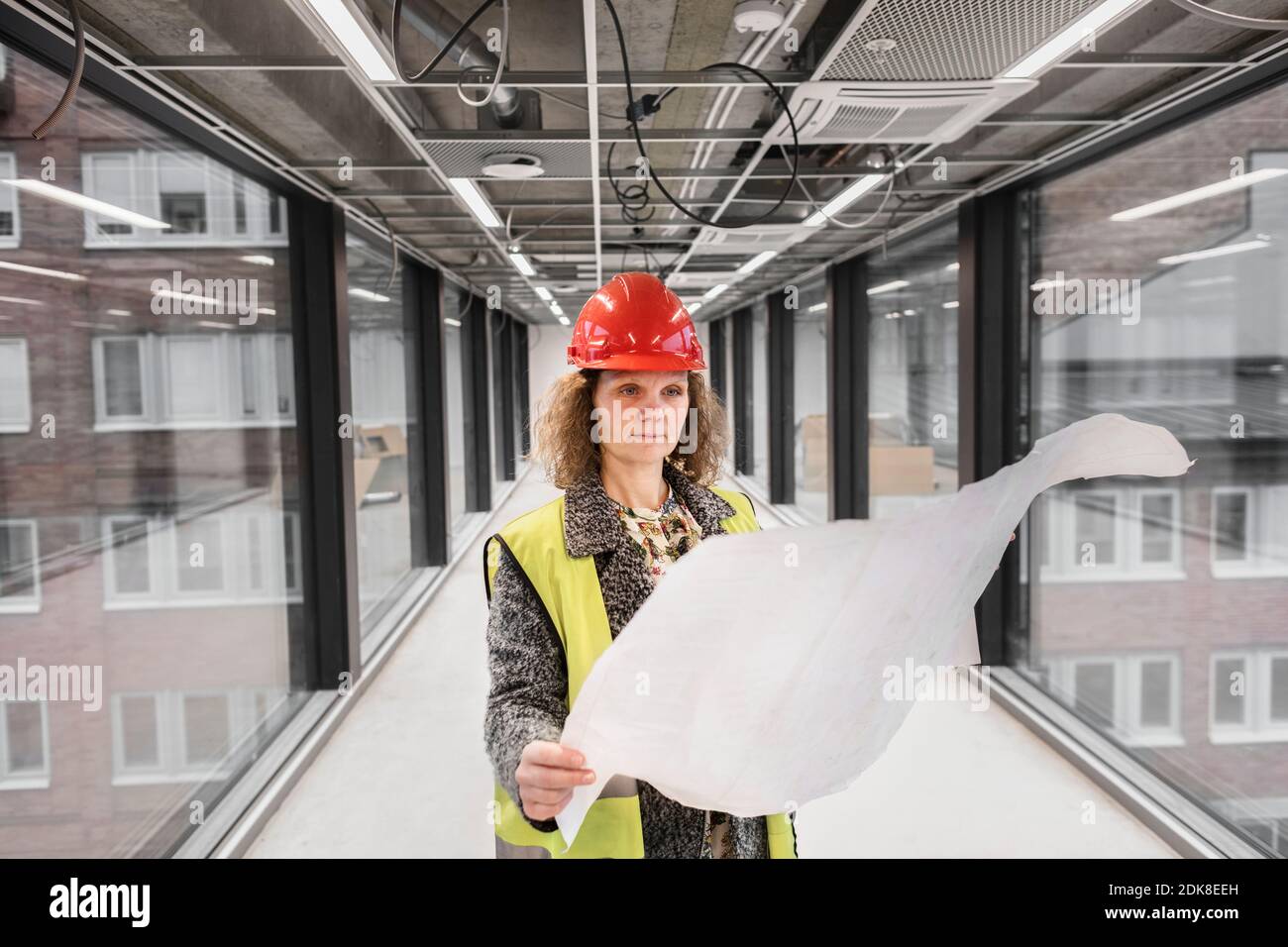 Female worker looking at blueprints Stock Photo