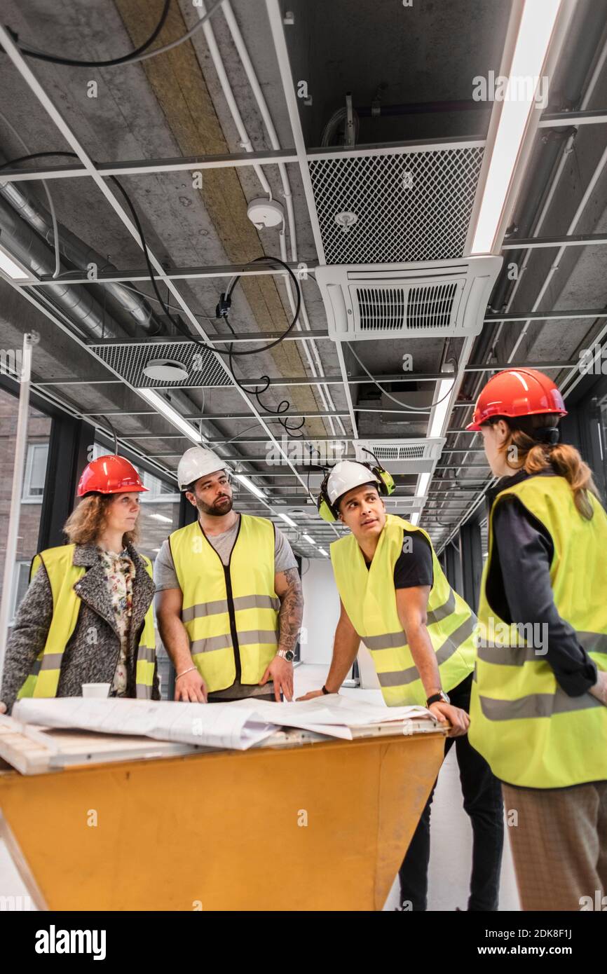 Workers at construction site Stock Photo - Alamy