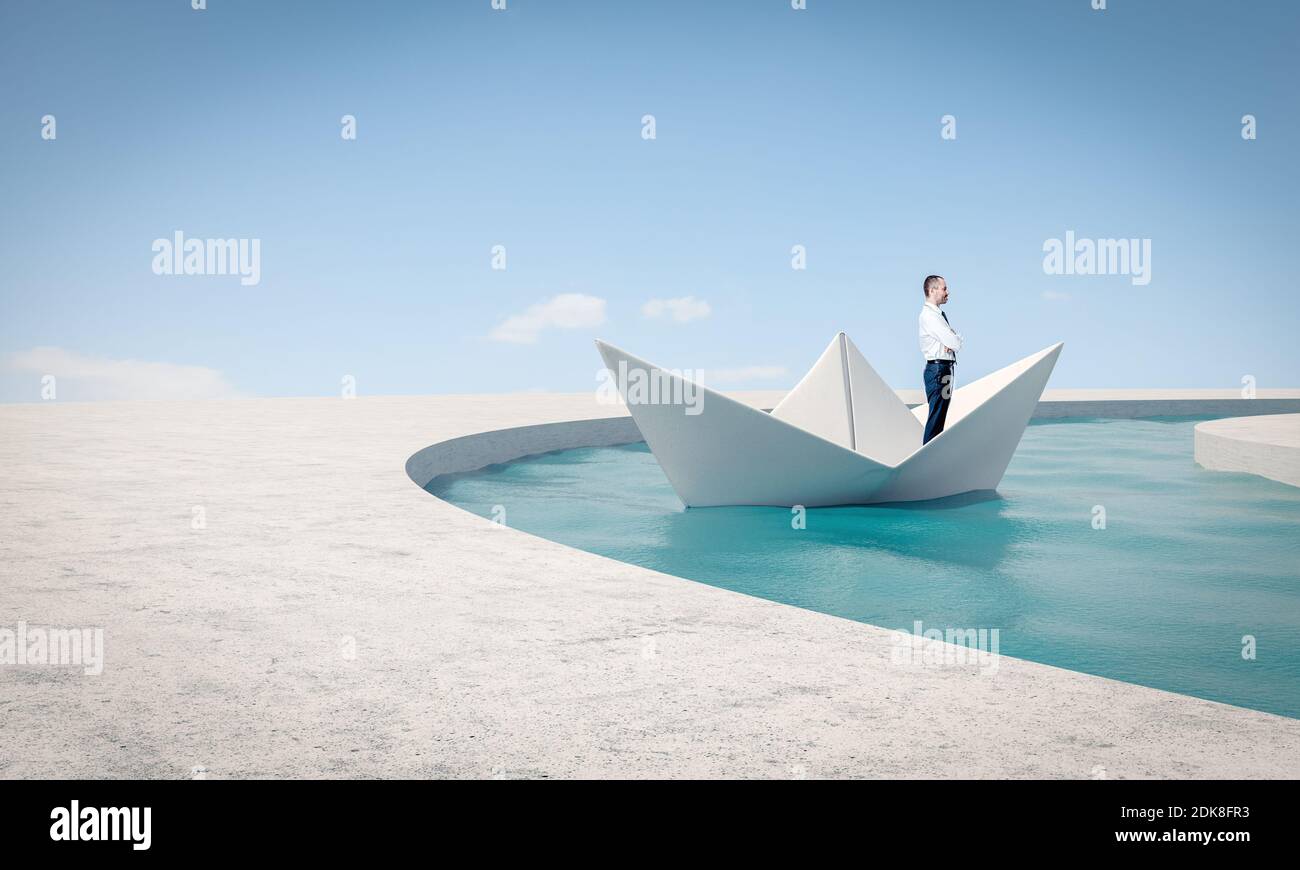 man uses a paper boat to solve a problem. concept of brainstorming and creativity. Stock Photo