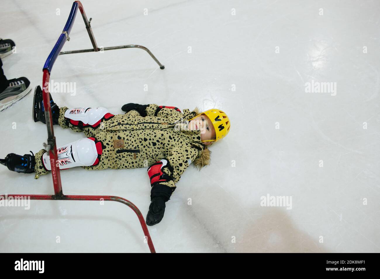 Girl lying ion ice rink Stock Photo - Alamy