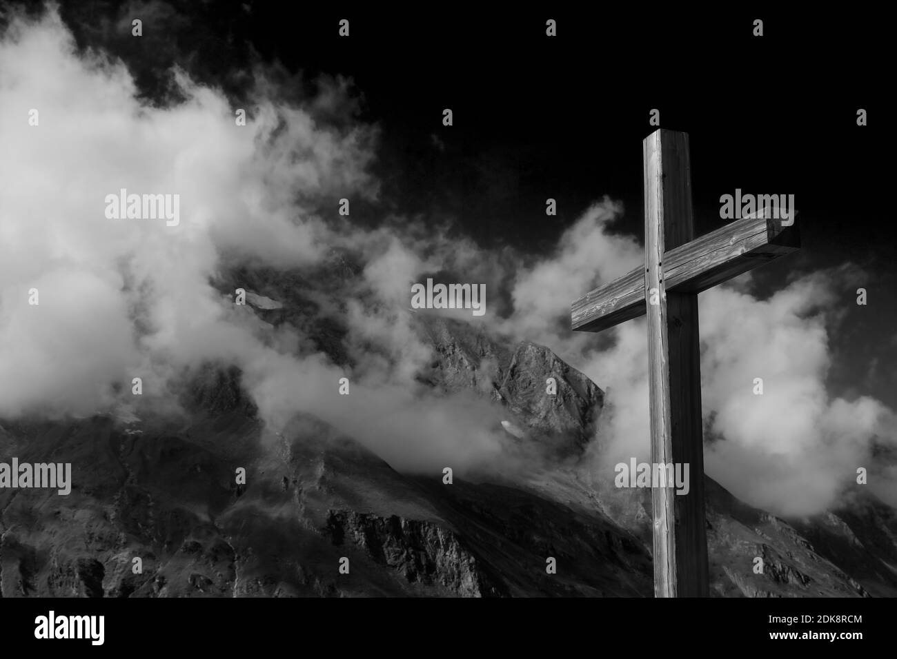 Plain Wooden Summit Cross Jesus Christ Crucifixion With Alps Mountain Ranges And Thick Clouds