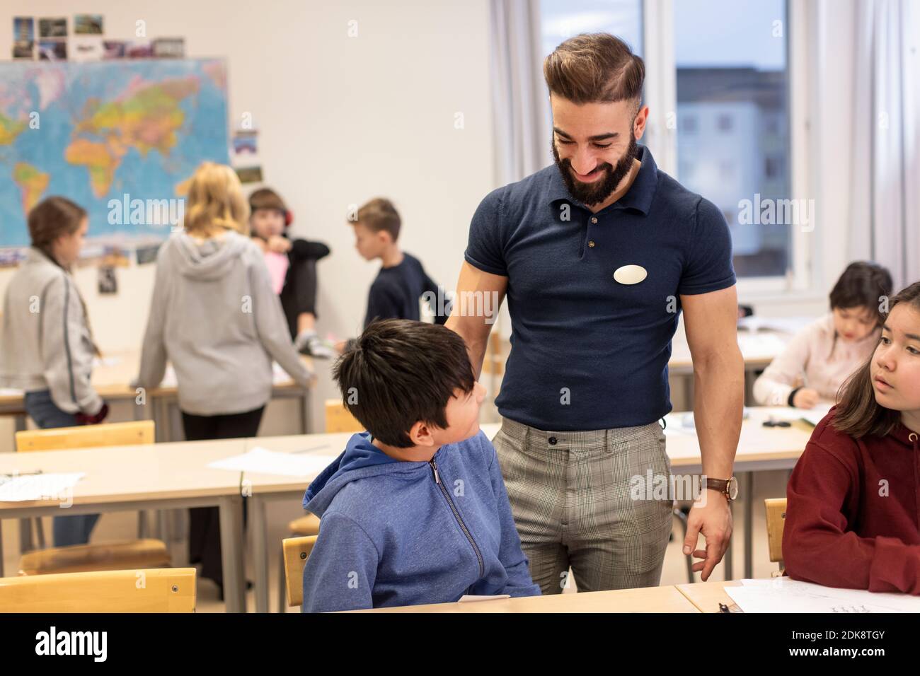 Teacher with schoolboy in classroom Stock Photo