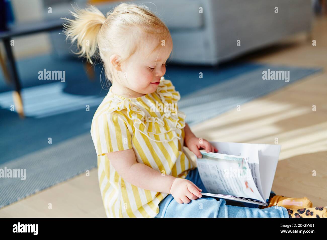 Happy girl with book Stock Photo - Alamy