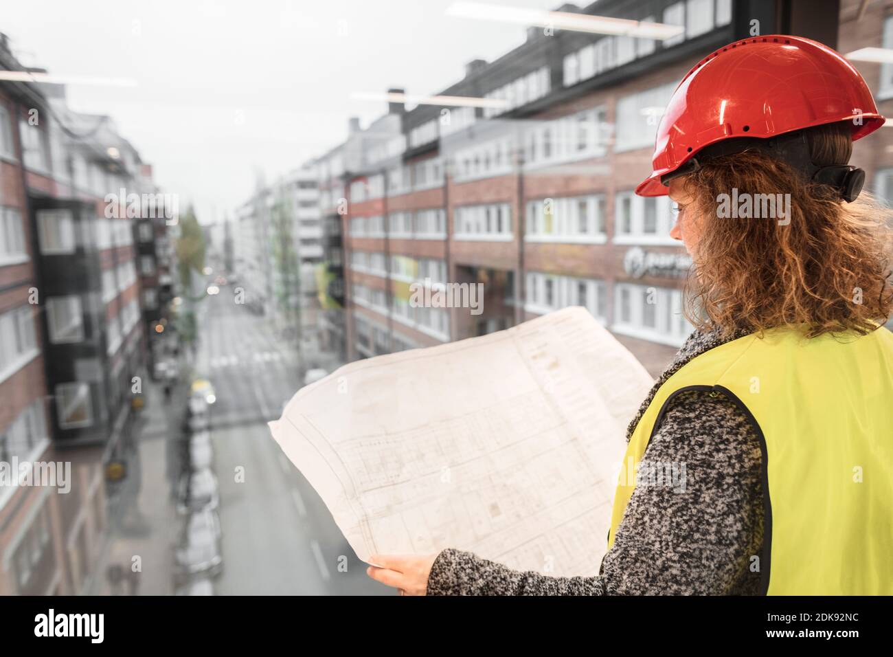 Female worker looking at blueprints Stock Photo