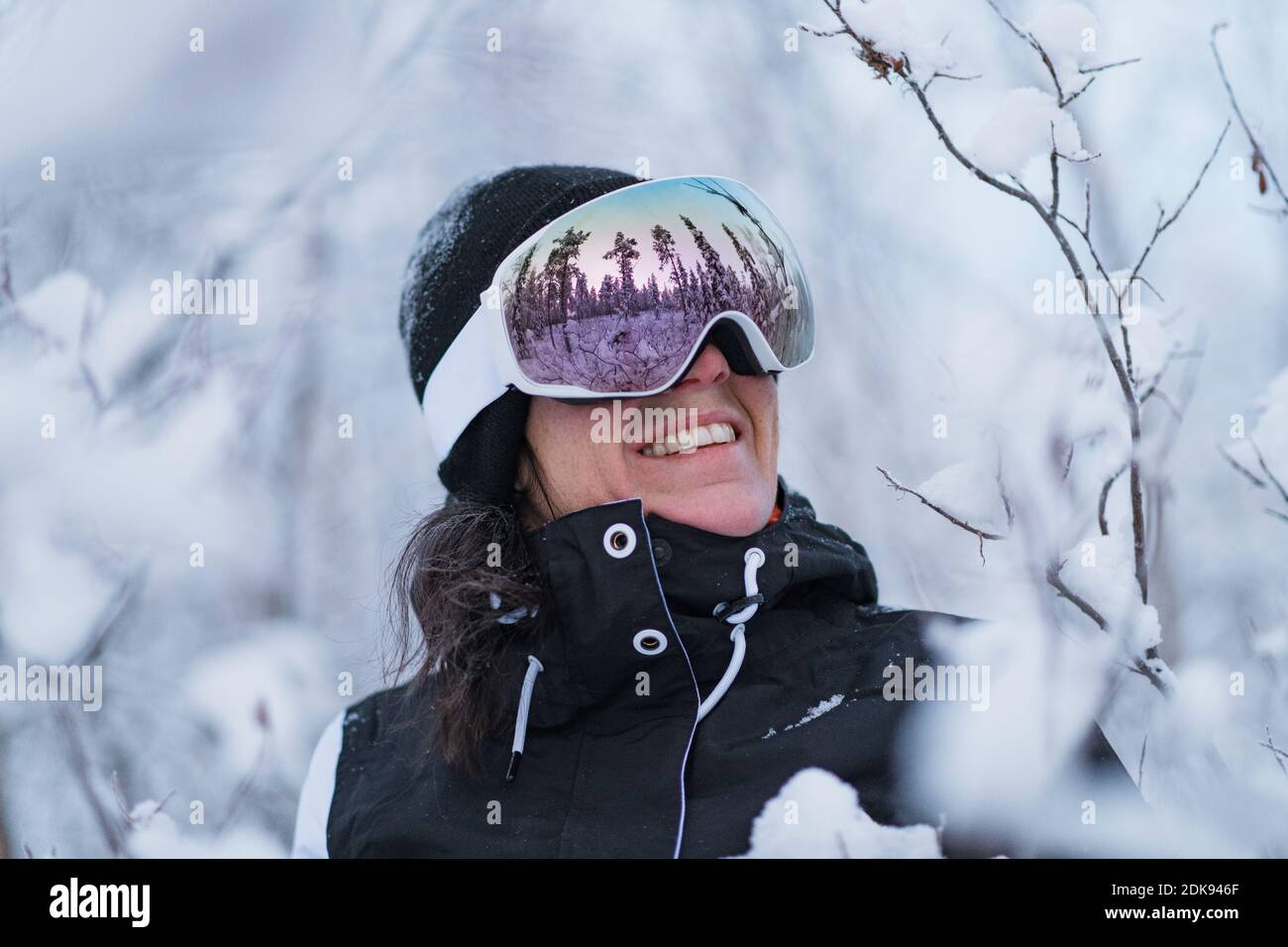 Smiling woman wearing ski goggles Stock Photo