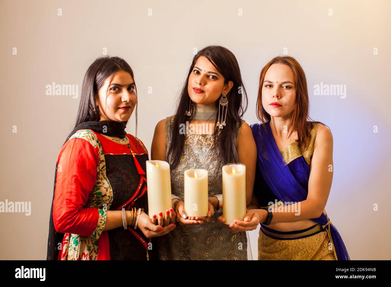 Three women with candles for traditional festival of lights Stock Photo ...