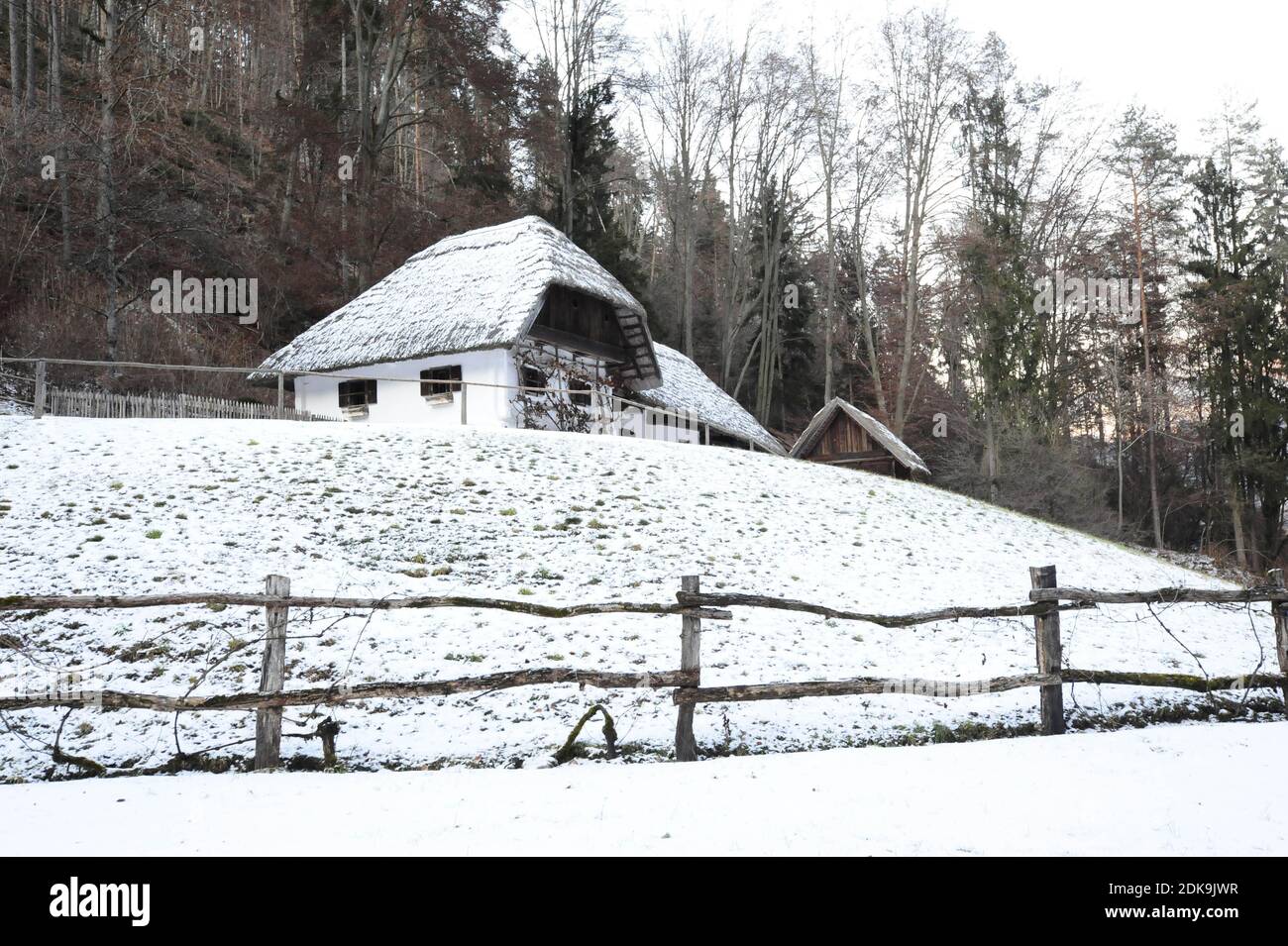 mountain farm and farmhouse in winter, living in the countryside in the mountains Stock Photo