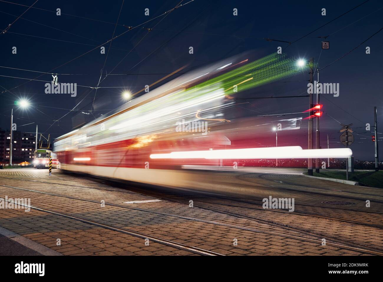 Tram in motion. Station of public transportation at night. Prague, Czech Republic Stock Photo