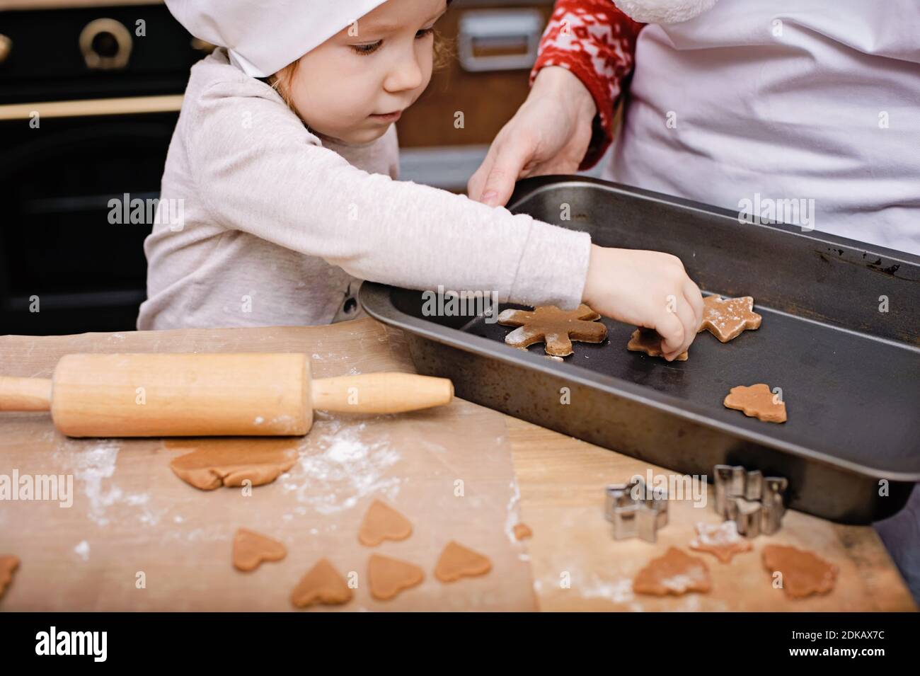 Children Making Gingerbread happy family mother and children son and daughter bake cookies for ...
