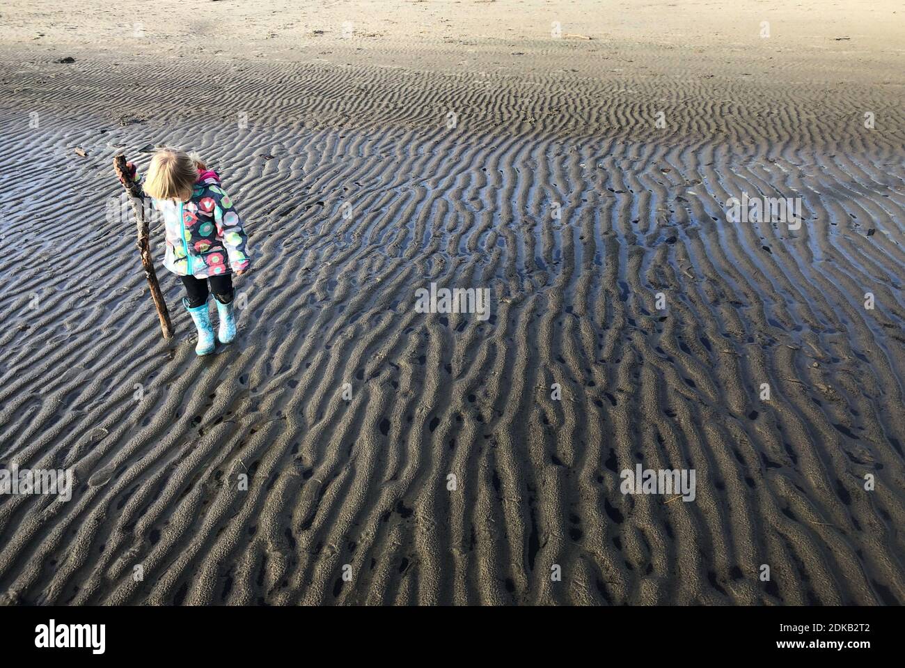 Girl Standing At Beach Stock Photo