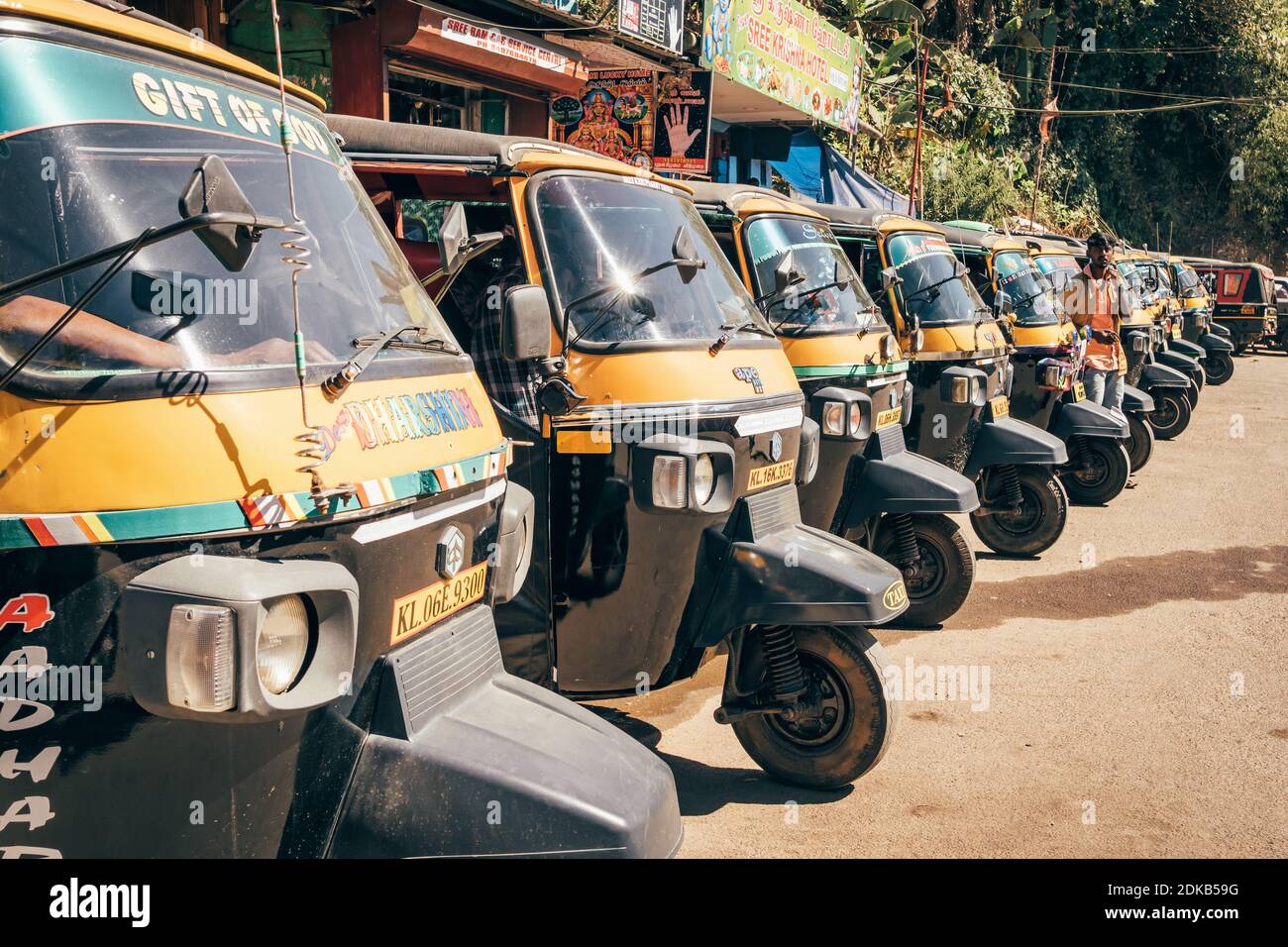 A row of parked colorful tuk-tuk auto rickshaws in Munnar, Kerala, India Stock Photo