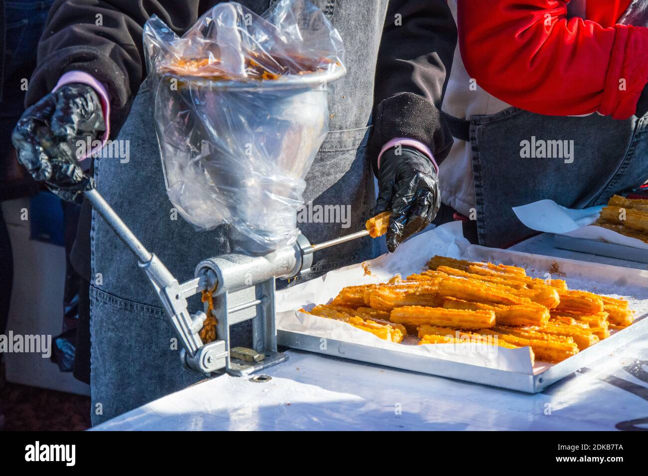 Midsection Of Person Preparing Churros On Table Stock Photo